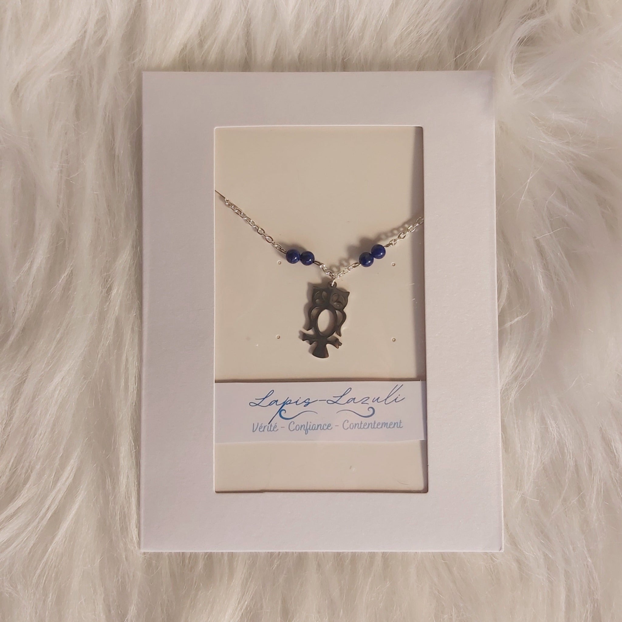 Bracelet Charm hibou en lapis-lazuli sur fond blanc, symbolisant la sagesse et l'intuition, présenté dans un emballage élégant.